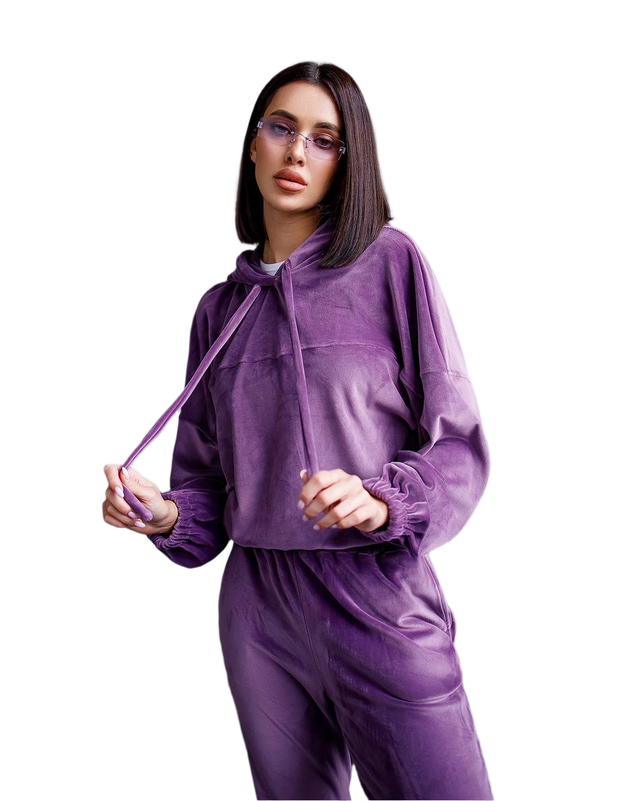 Woman wearing a purple tracksuit on a white background