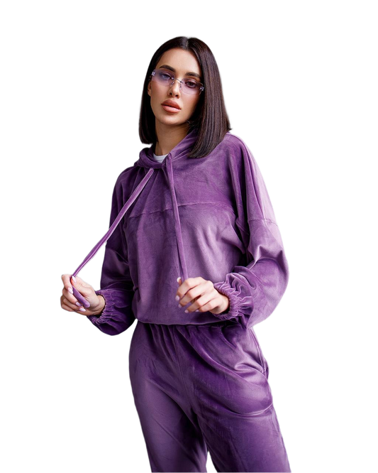 Woman wearing a purple tracksuit on a white background