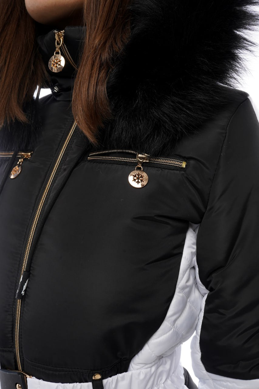 Close-up of a black jacket with fur hood and gold zippers on a white background