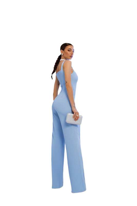 Woman wearing a light blue jumpsuit on a white background
