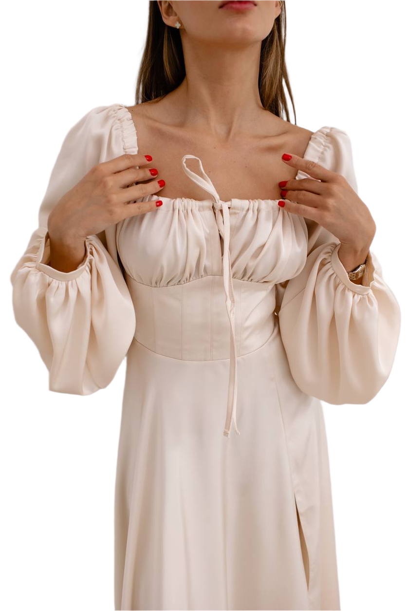 Beige dress with long sleeves and a fitted waist on a white background