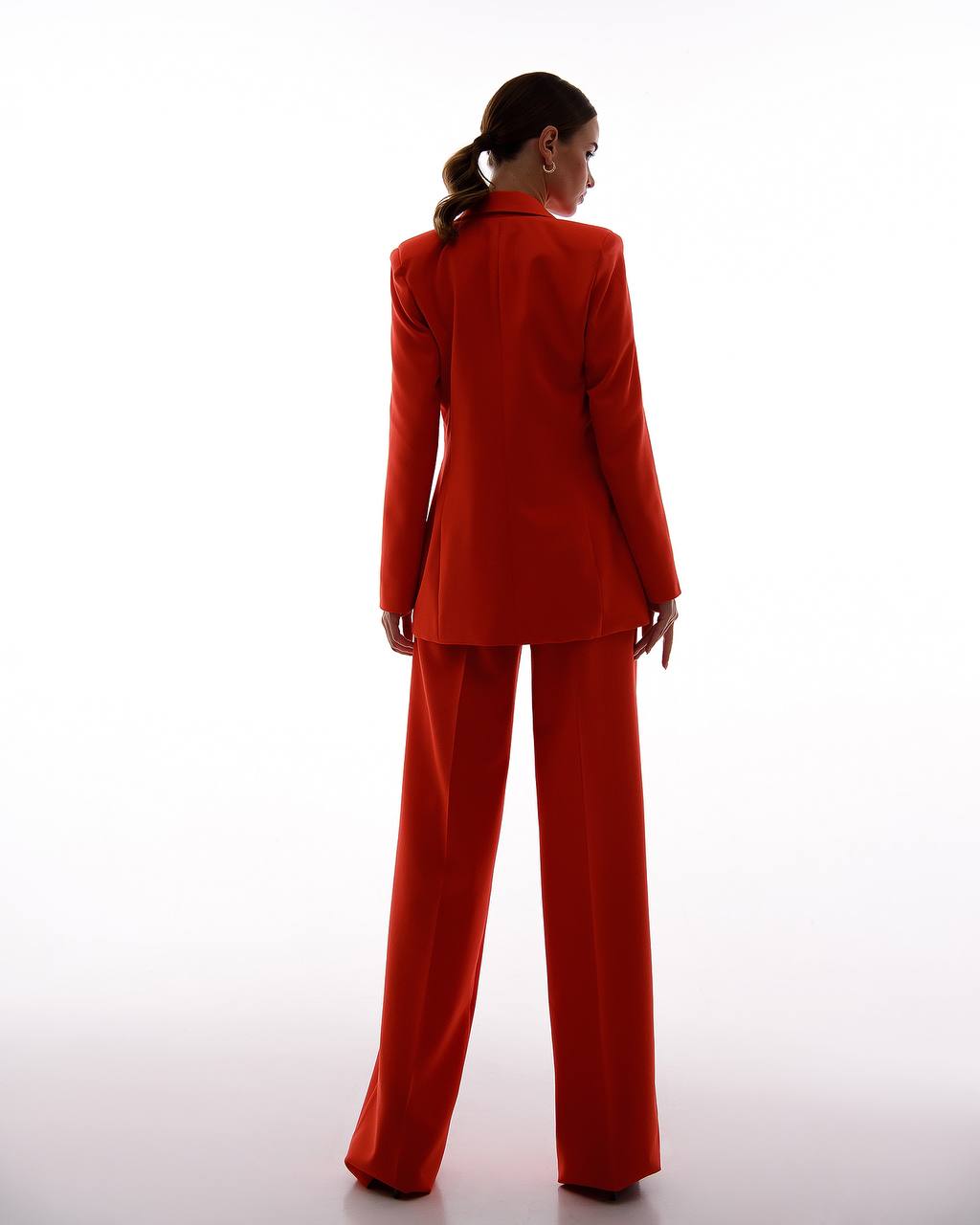 Person wearing a red suit on a white background