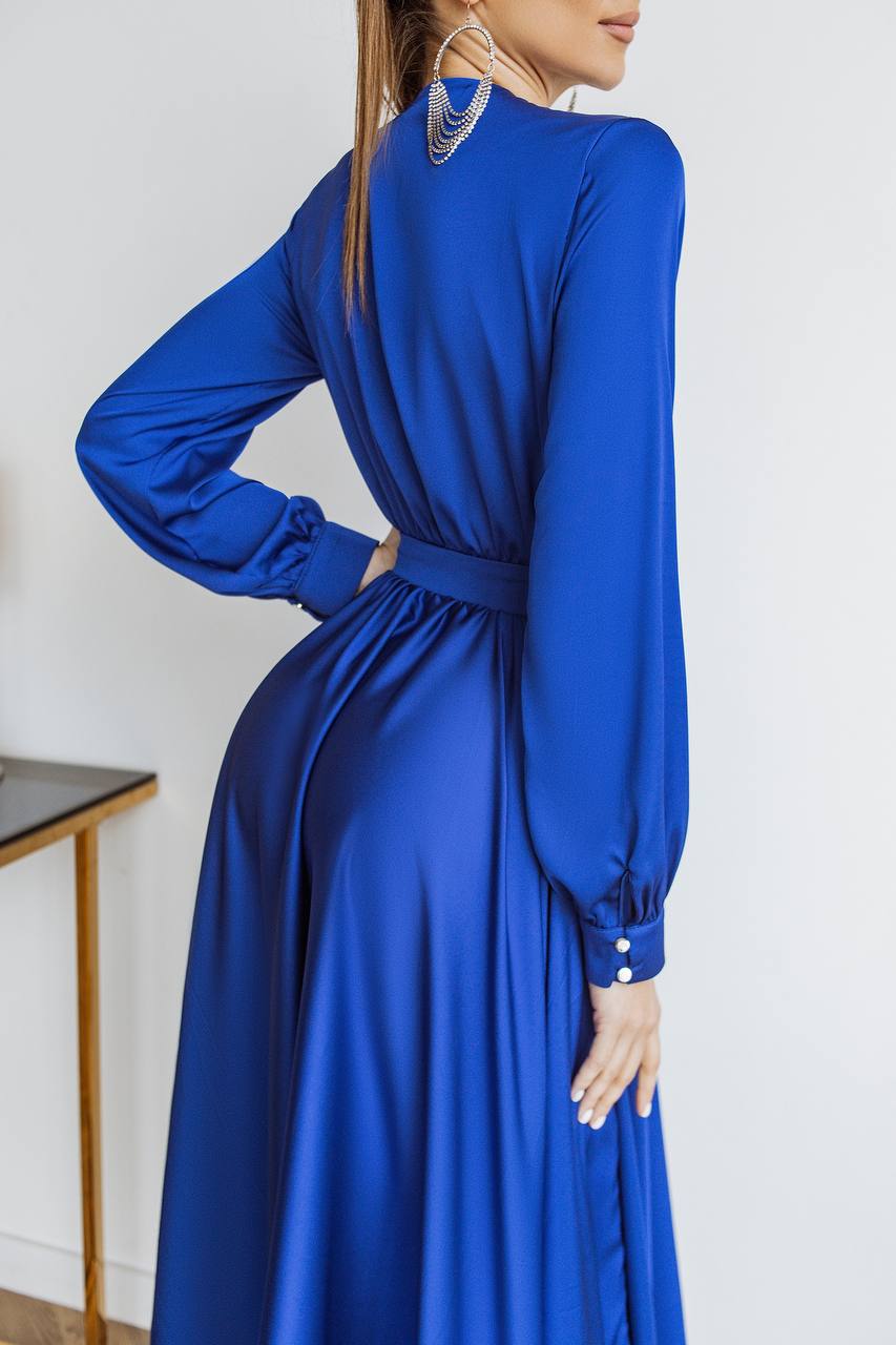 Blue dress with long sleeves on a plain background