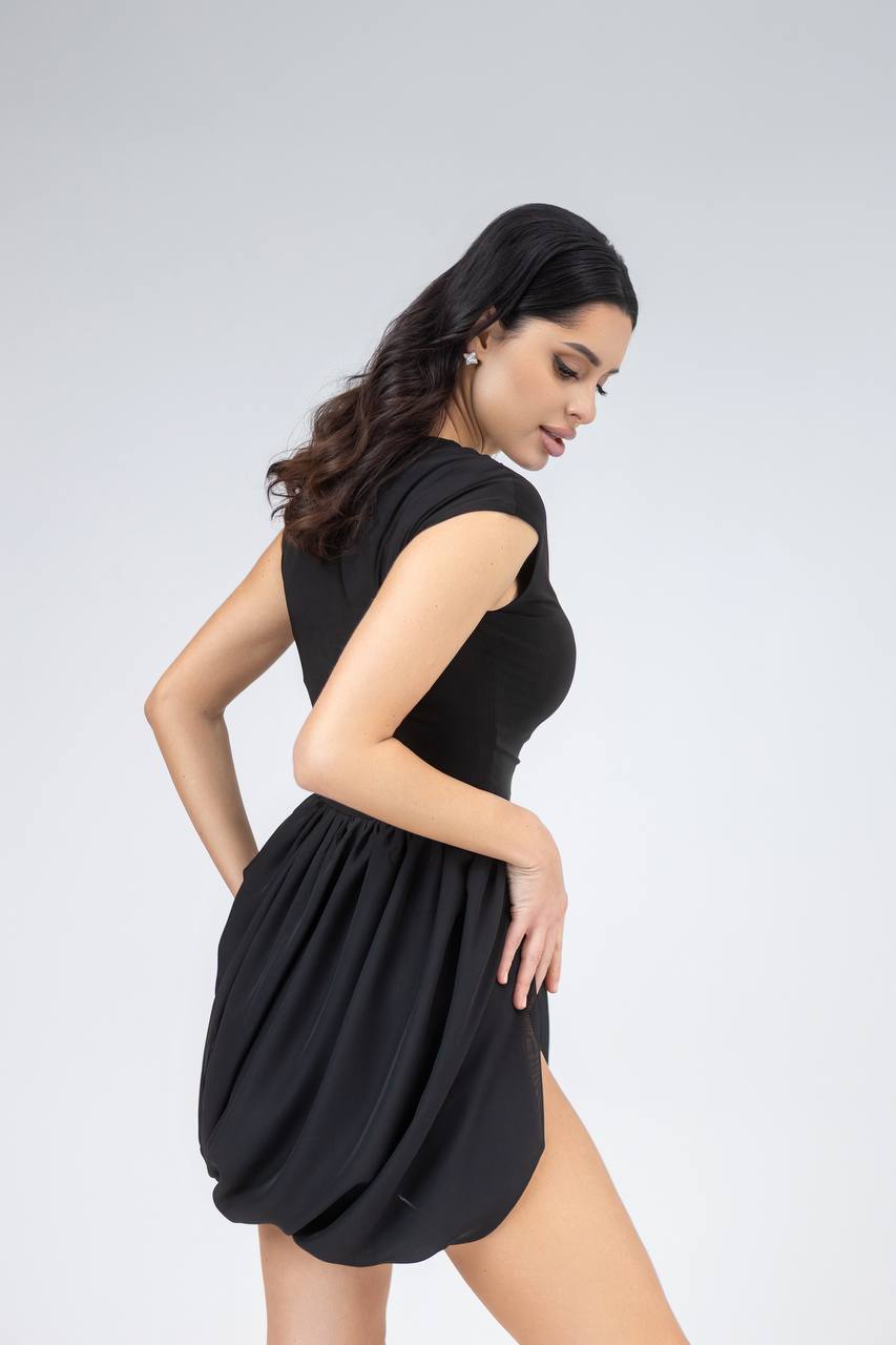 Woman wearing a black dress on a gray background