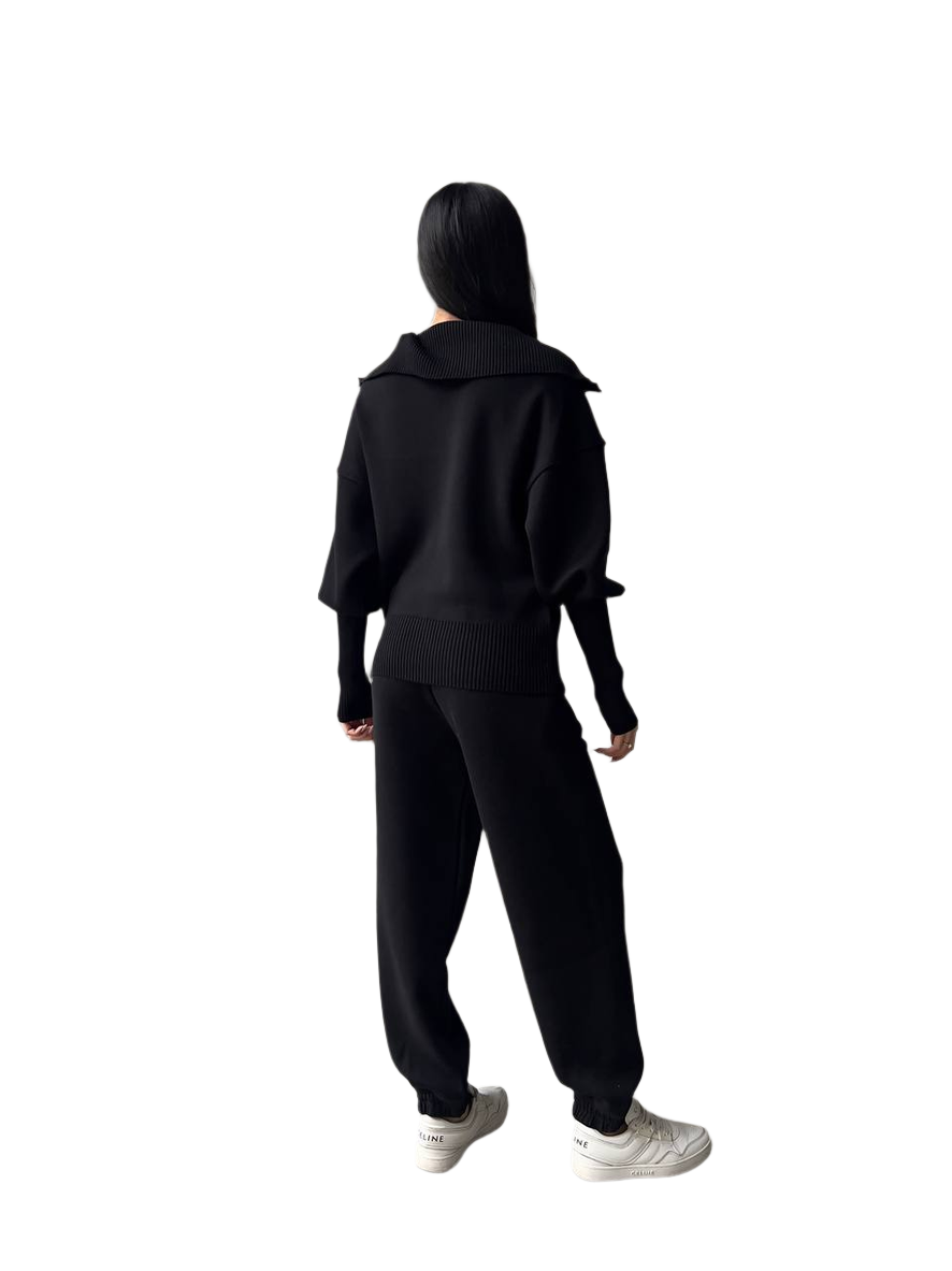 Person wearing a black tracksuit on a white background