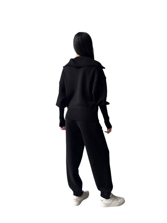 Person wearing a black tracksuit on a white background