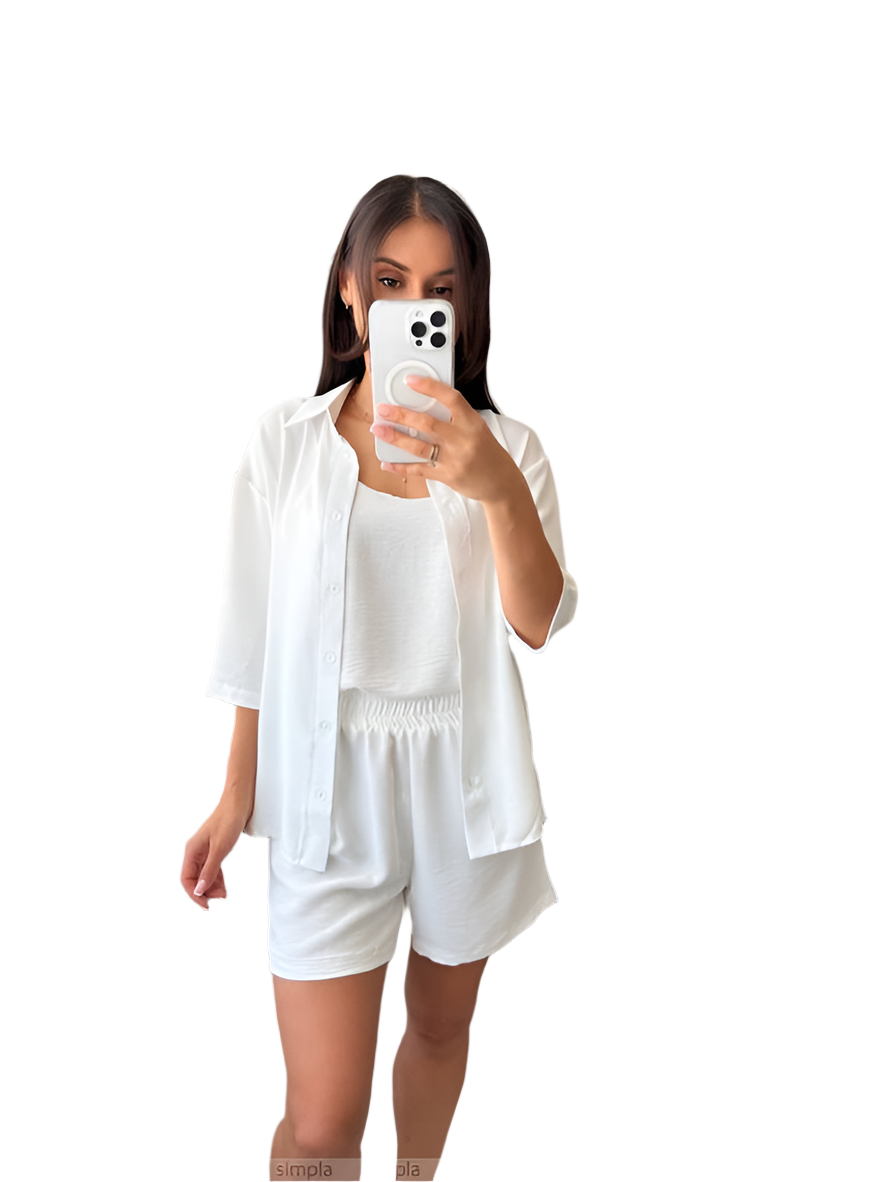 Woman taking a selfie in a white outfit on a white background