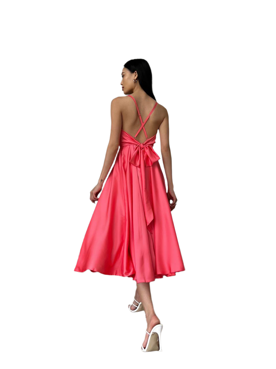 Woman wearing a pink dress with a bow detail on a white background