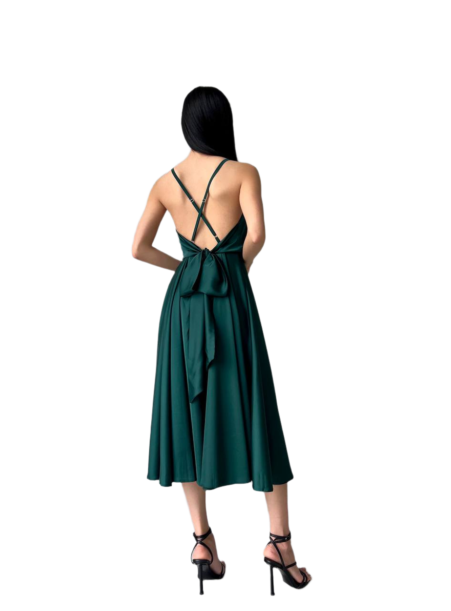 Woman wearing a green dress with a bow detail on a white background