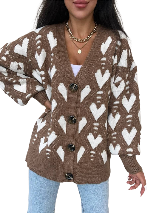 Brown cardigan with white heart pattern worn by a person on a white background