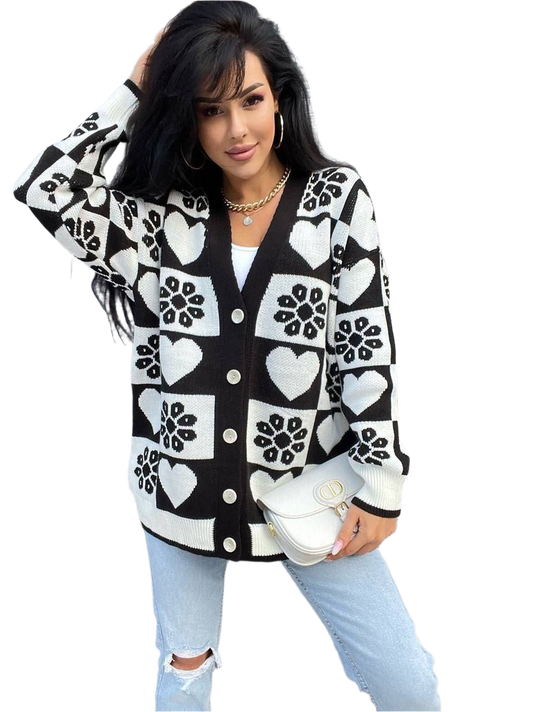 Woman wearing a black and white patterned cardigan on a white background
