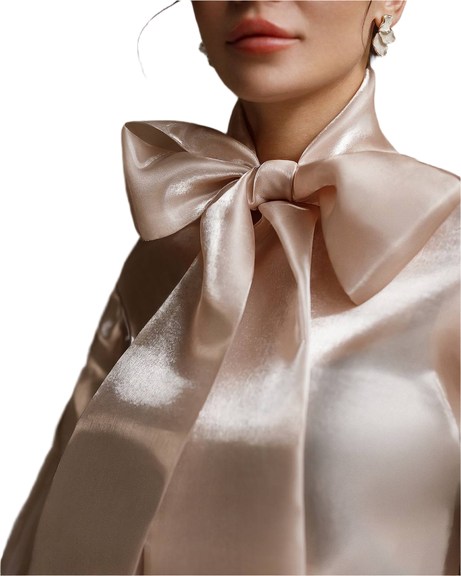 Close-up of a person wearing a large satin bow tie on a white background