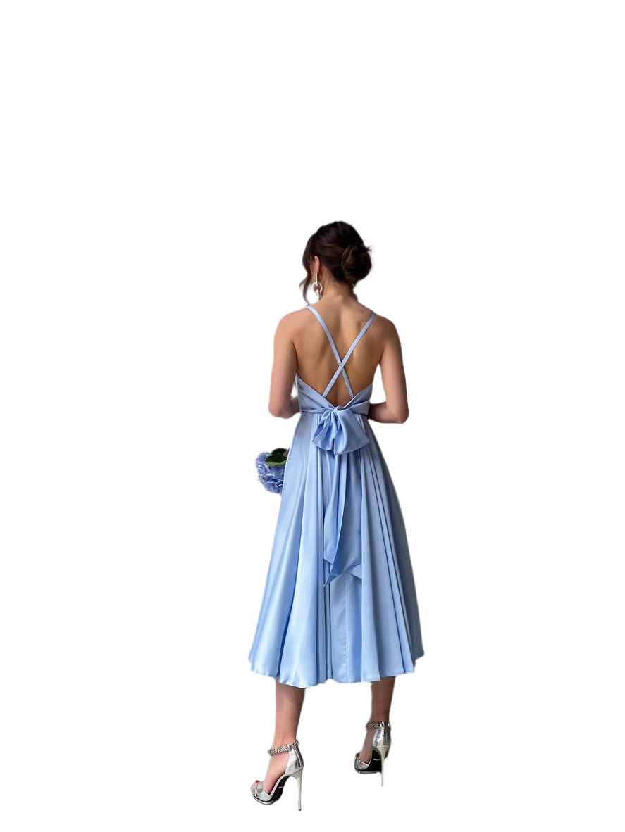 Woman wearing a light blue dress with a bow detail on a white background