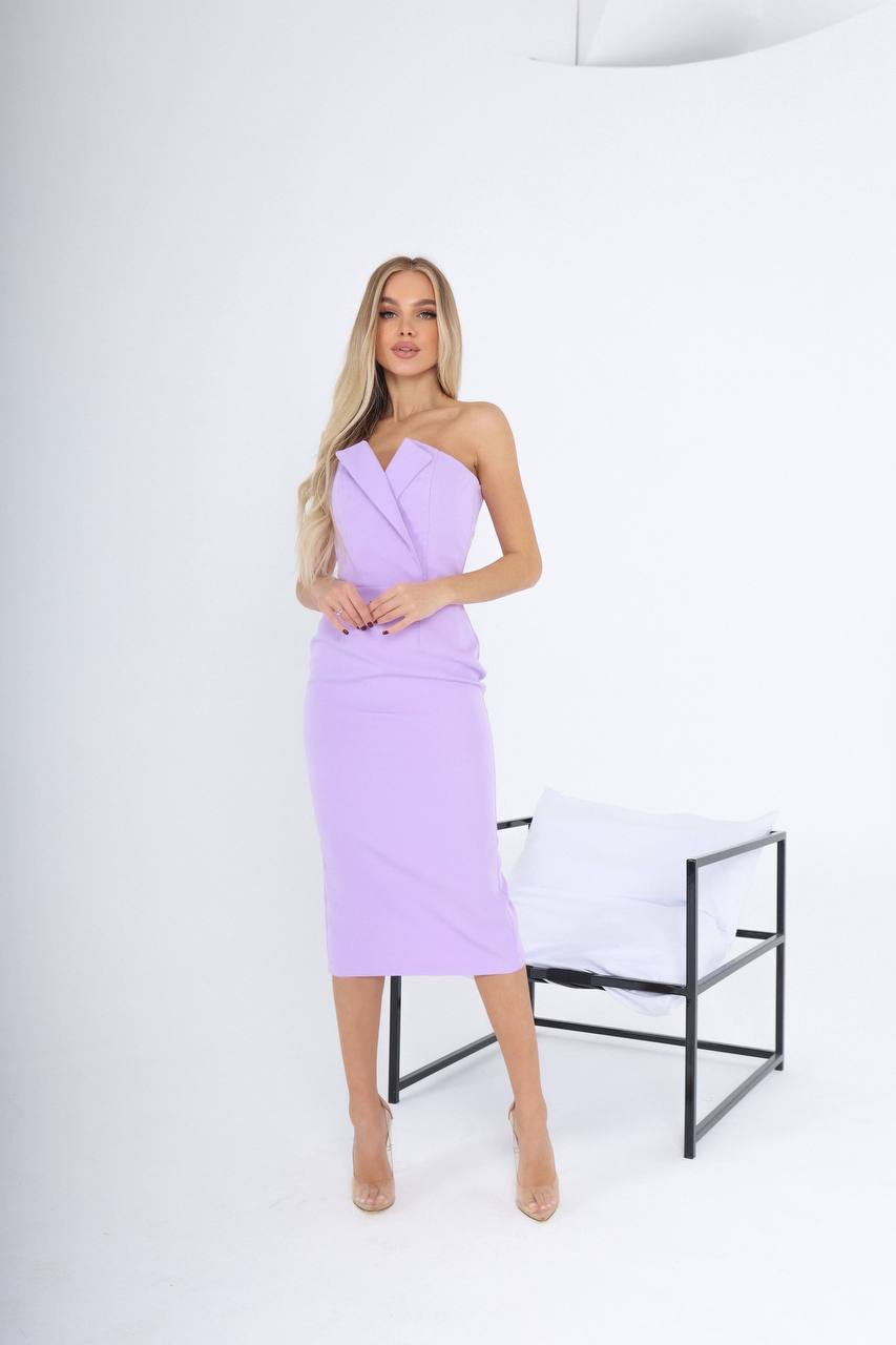 Woman wearing a light purple strapless dress against a white background