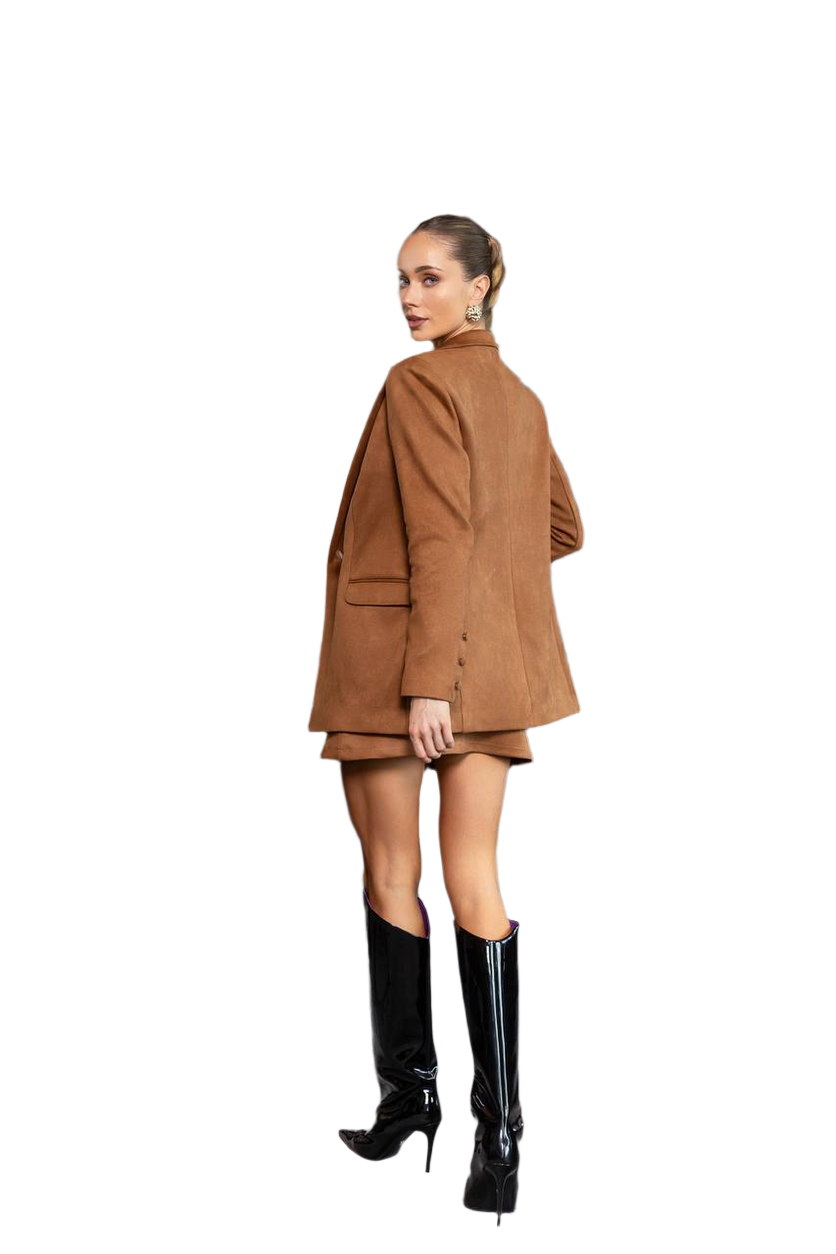 Woman wearing a brown coat and black boots on a white background