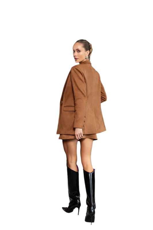 Woman wearing a brown coat and black boots on a white background