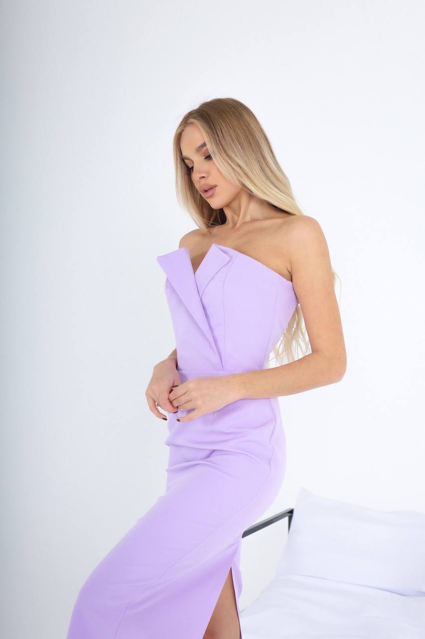 Woman wearing a one-shoulder lavender dress on a white background