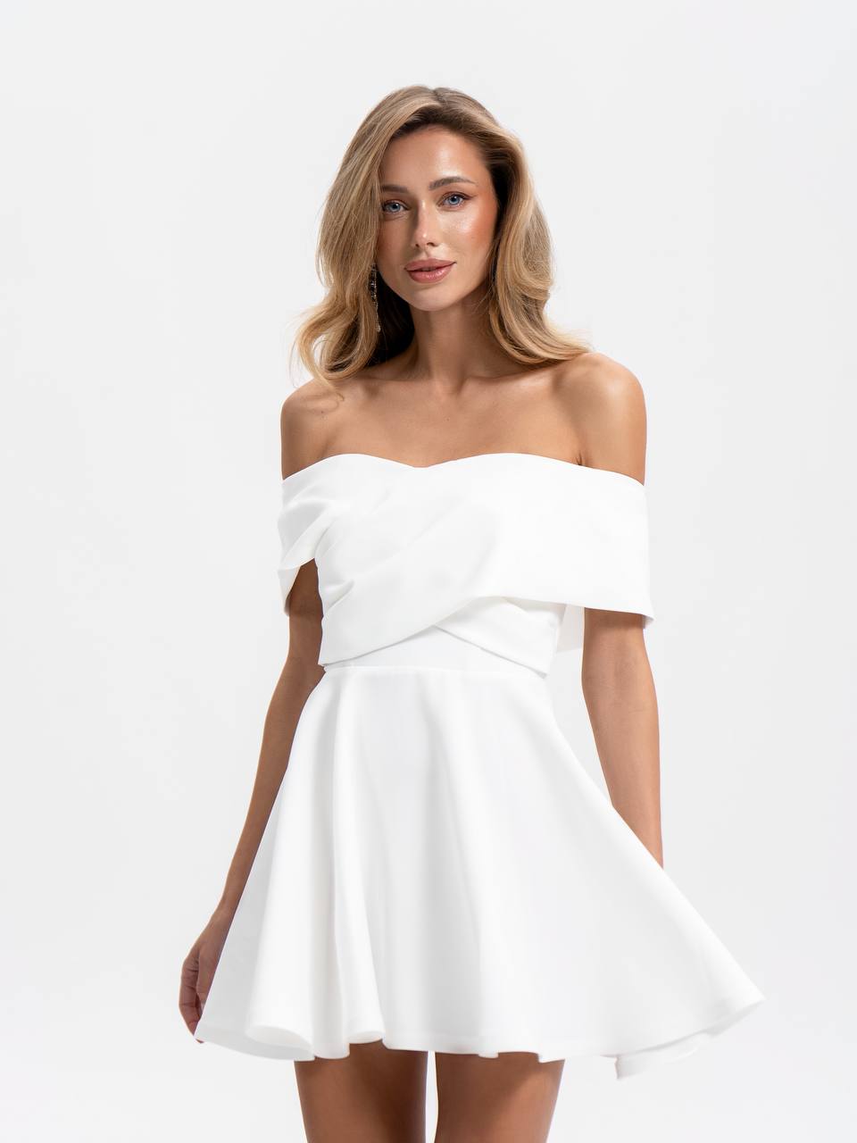 Woman wearing a white off-shoulder dress on a white background