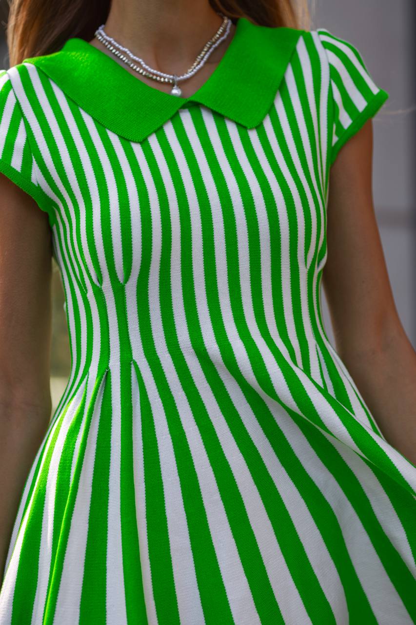 Green and white striped dress with a collar worn by a person.