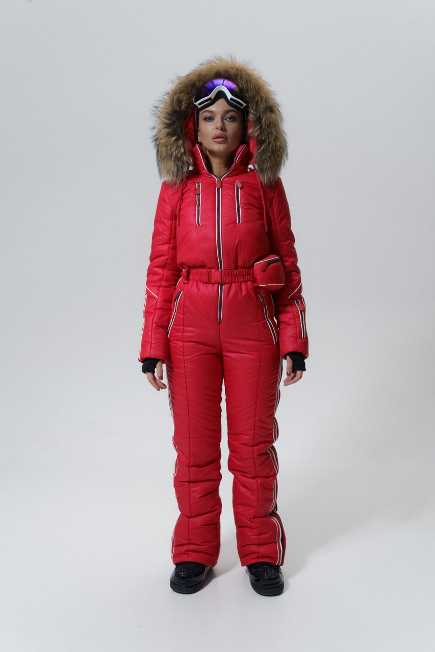 Person wearing a red snowsuit with a fur-lined hood on a white background