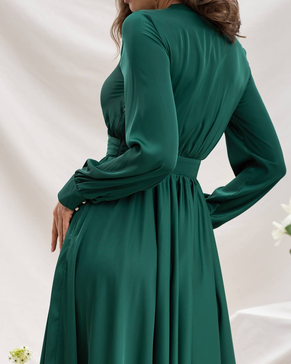 Green dress with long sleeves on a white background