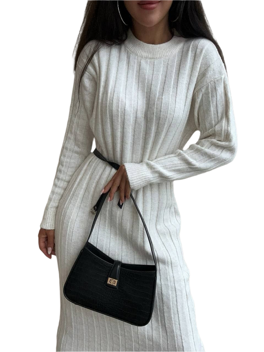 Woman wearing a white ribbed sweater dress holding a black handbag on a white background