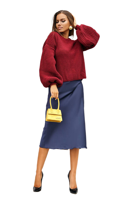 Woman wearing a red sweater and blue skirt with a yellow handbag on a white background