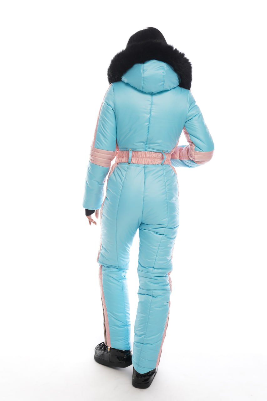 Light blue ski jumpsuit with pink accents on a white background