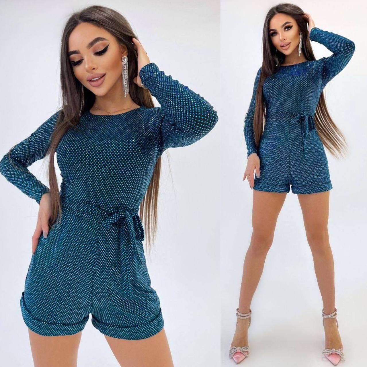 Woman wearing a blue textured romper on a white background