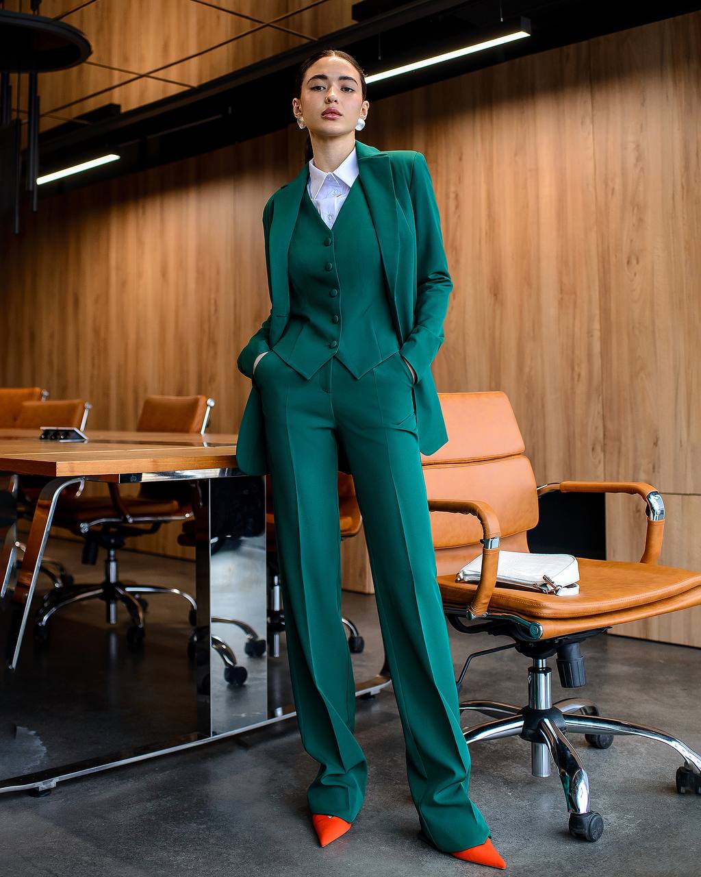 Person wearing a green suit in an office setting