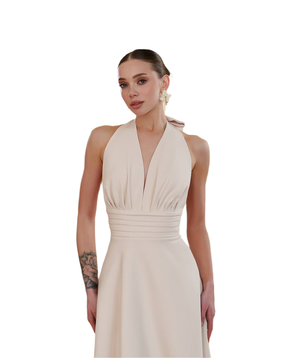 Woman wearing a beige halter neck dress on a white background