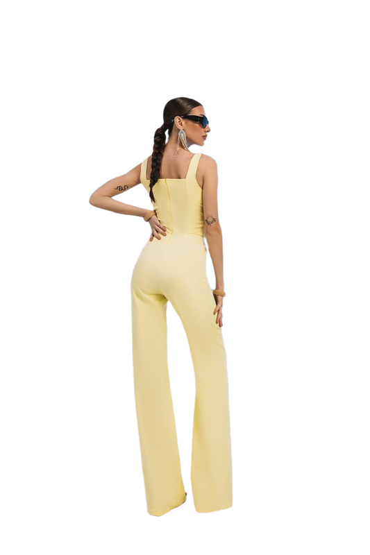 Woman wearing a yellow jumpsuit on a white background