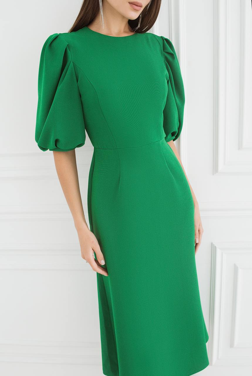 Green dress with puff sleeves on a white background