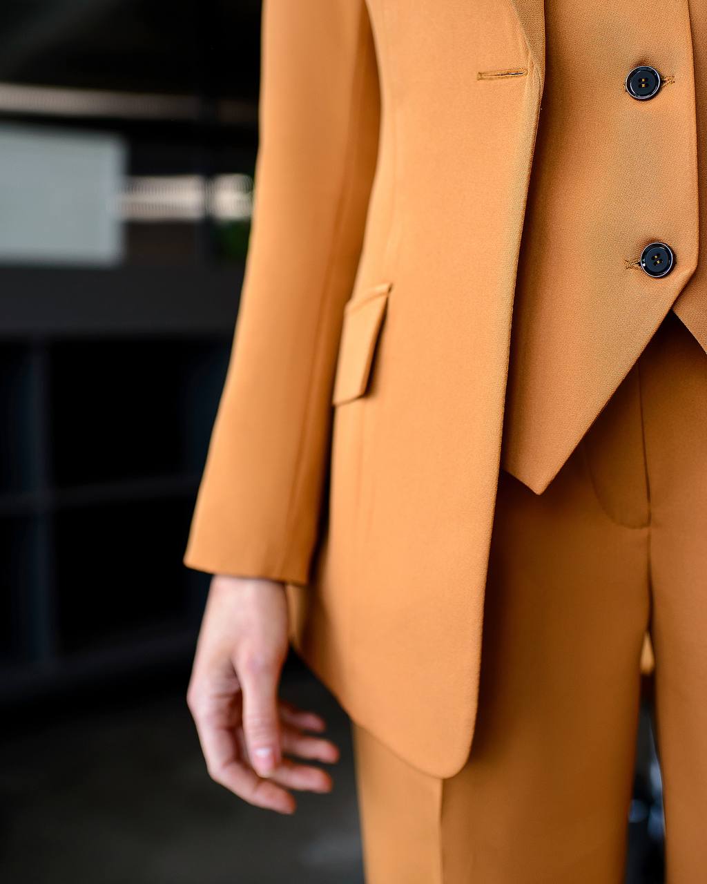 Close-up of a mustard yellow suit with a blurred background