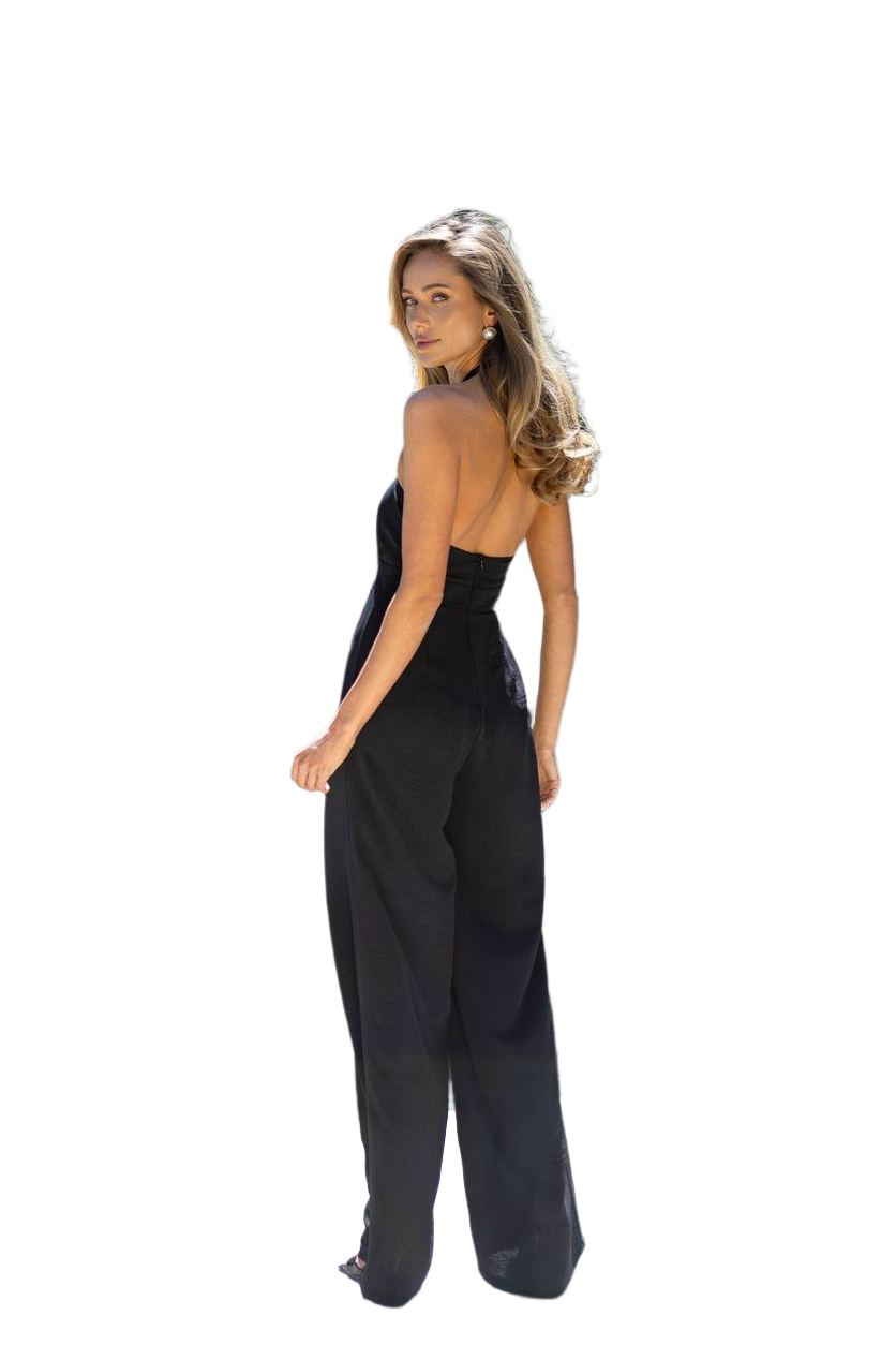 Woman wearing a black jumpsuit on a white background