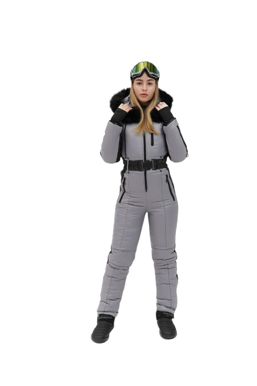 Person wearing a gray snowsuit with black boots and a helmet on a white background