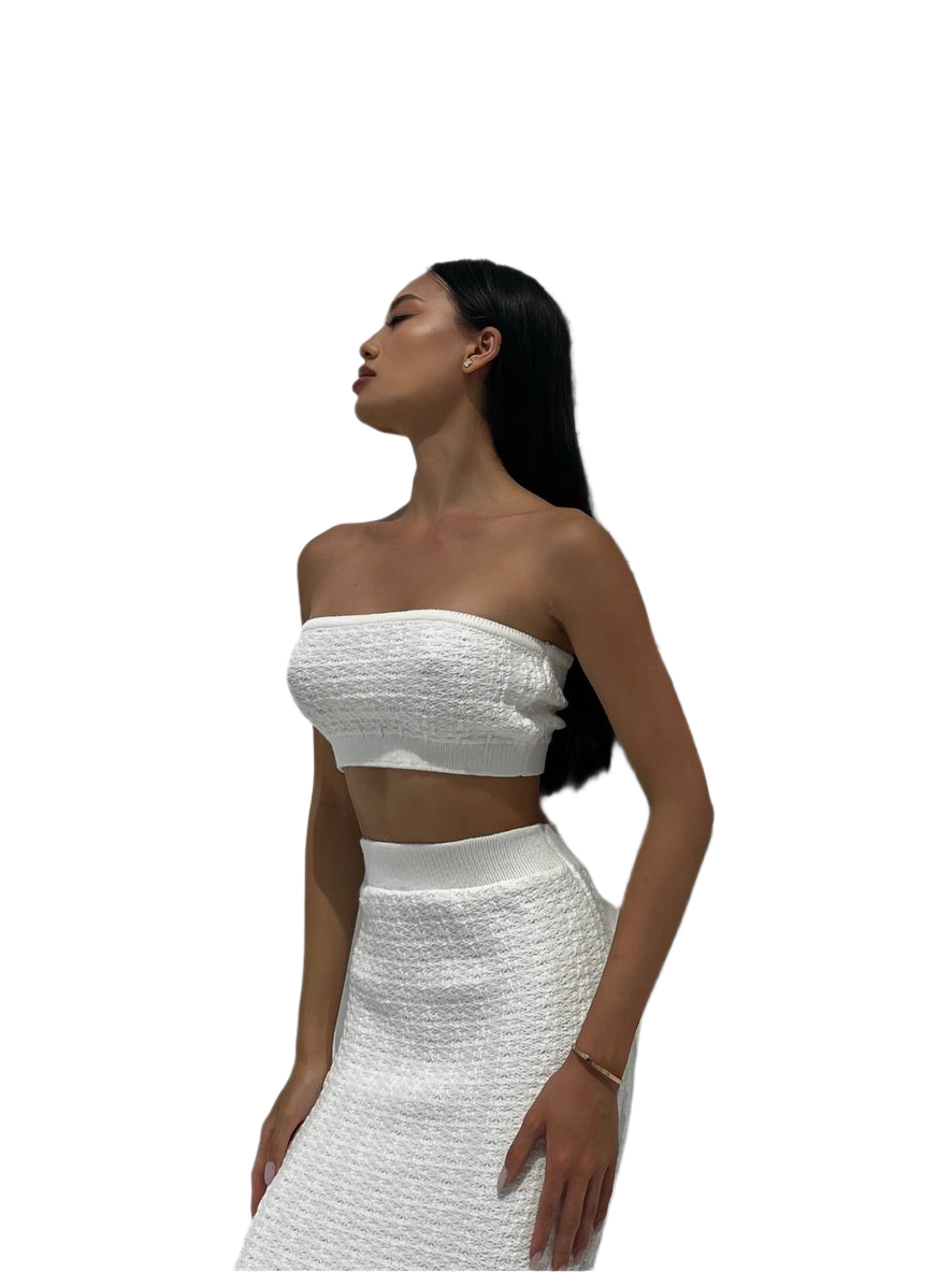 Woman wearing a white strapless top and skirt set on a white background