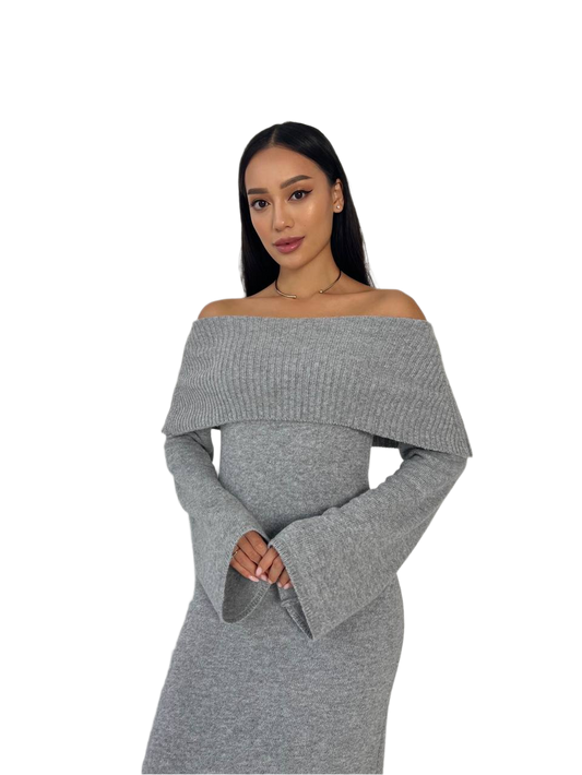 Woman wearing a gray off-shoulder dress on a white background