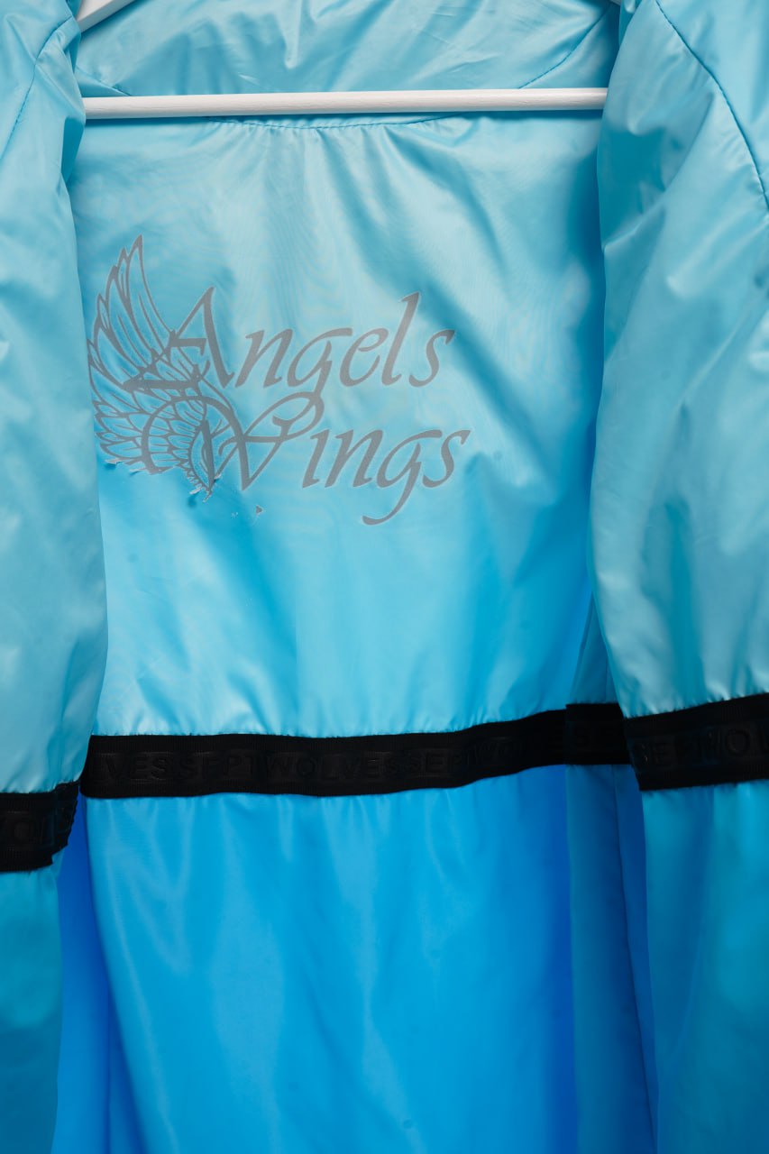 Blue jacket with 'Angels Wings' embroidery on a white background