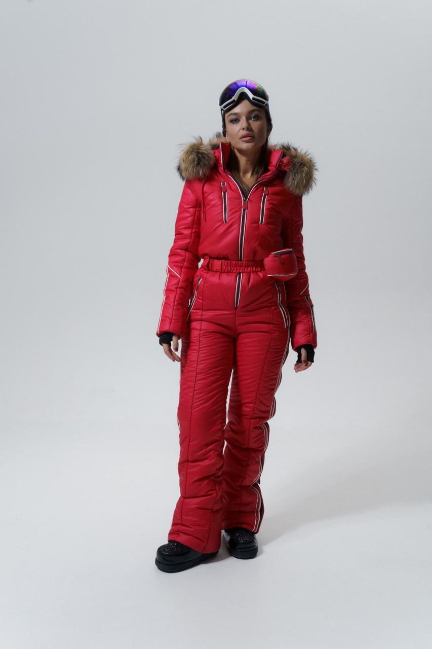 Person wearing a red snowsuit with a hood on a white background