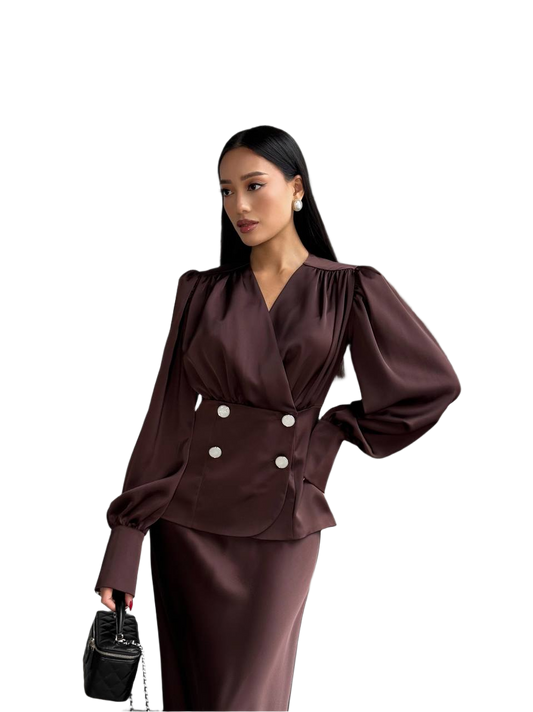 Woman wearing a brown satin outfit with white buttons on a white background