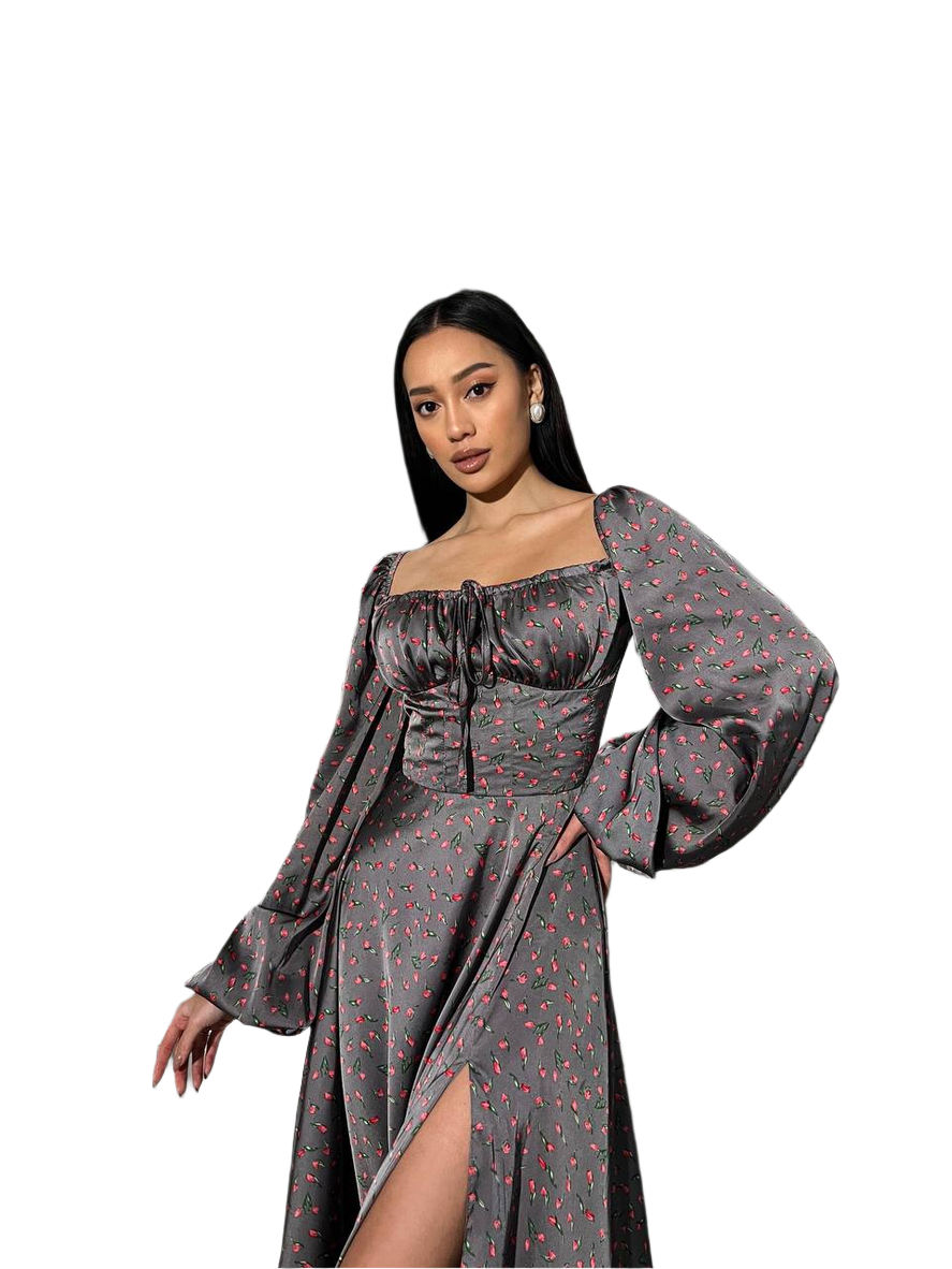 Woman wearing a gray dress with long sleeves and a slit on a white background
