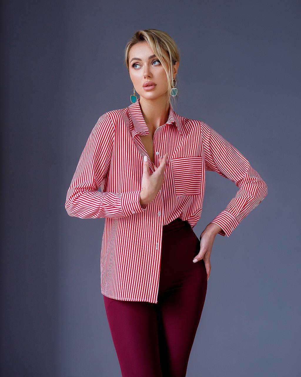 Woman wearing a red and white striped shirt with a gray background