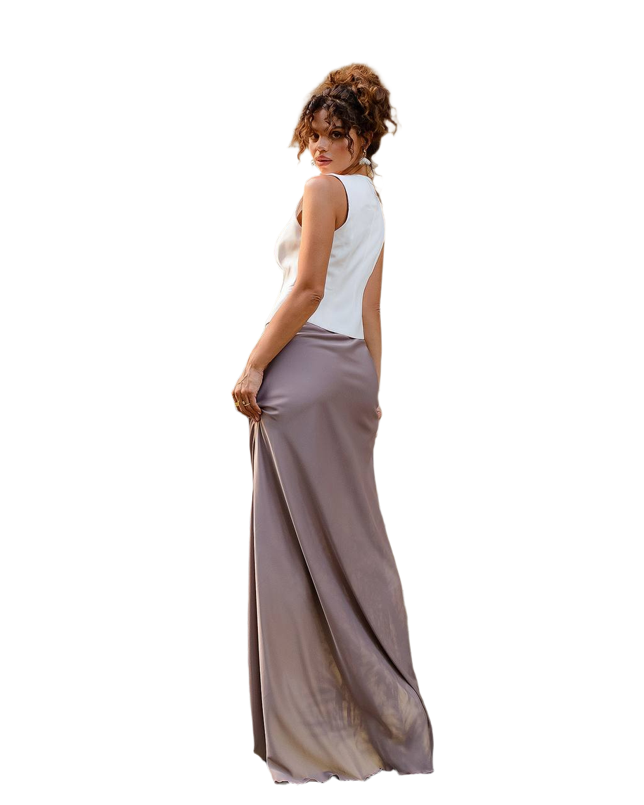 Woman wearing a white sleeveless top and long beige skirt on a white background