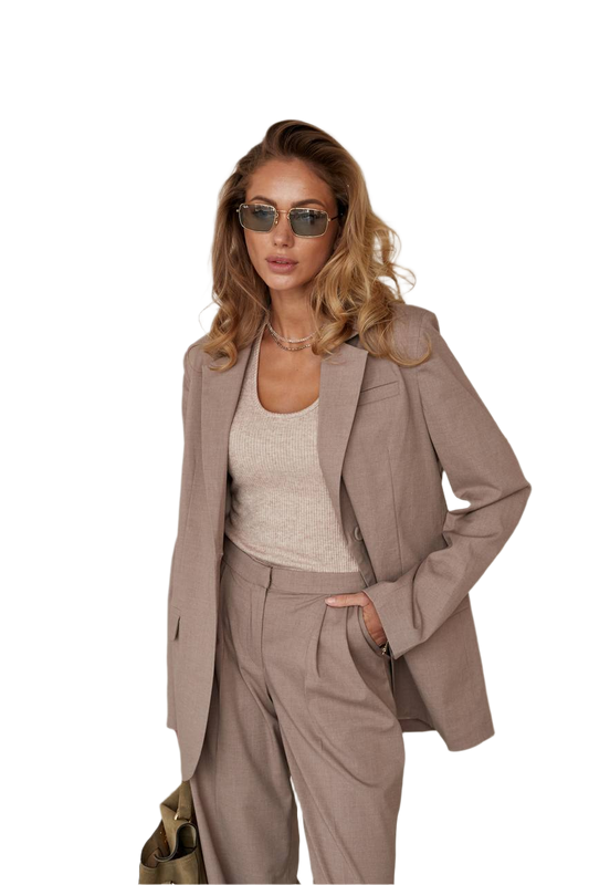 Woman wearing a beige suit and sunglasses on a white background