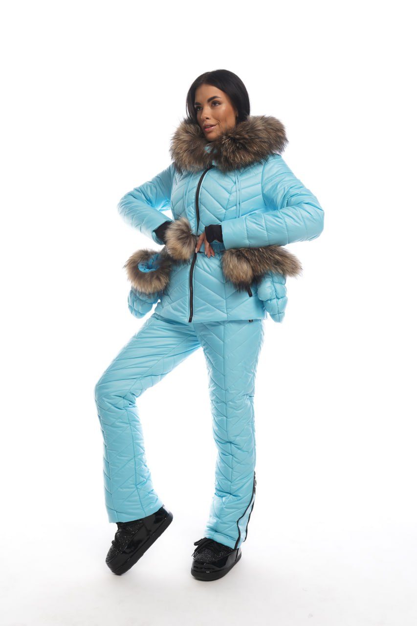 Person wearing a blue puffer suit with fur trim on a white background