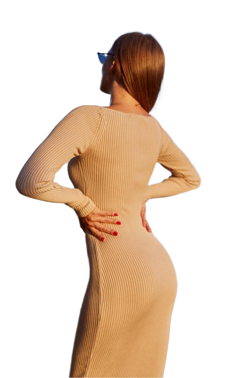 Woman wearing a beige ribbed dress on a white background