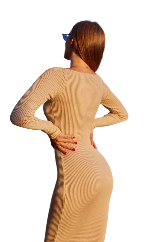 Woman wearing a beige ribbed dress on a white background