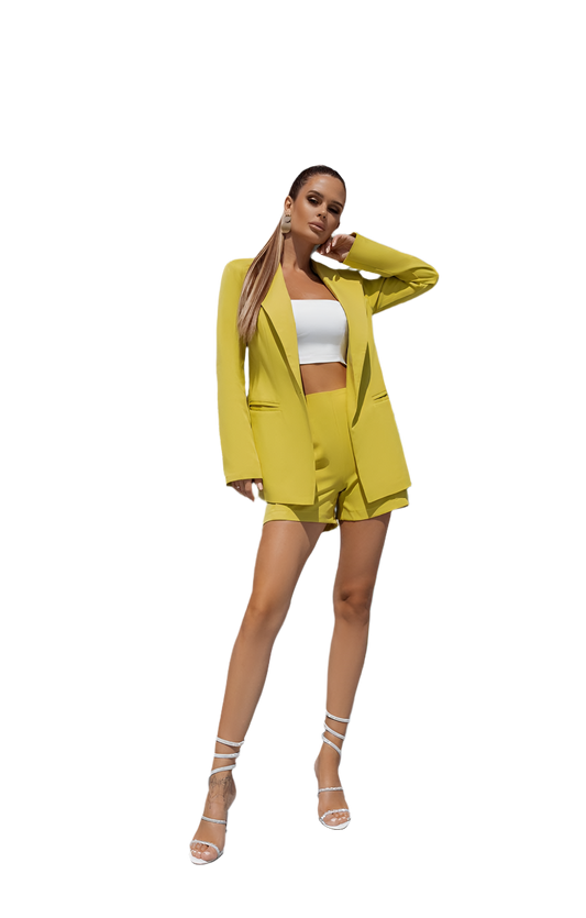 Woman wearing a bright yellow suit with a white top on a white background