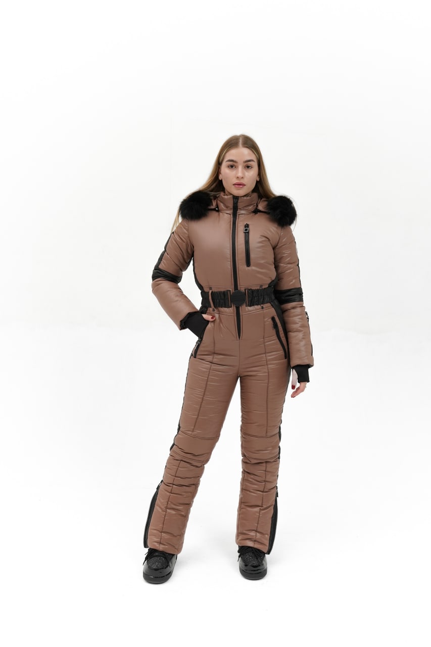 Person wearing a brown quilted jumpsuit with black accents on a white background